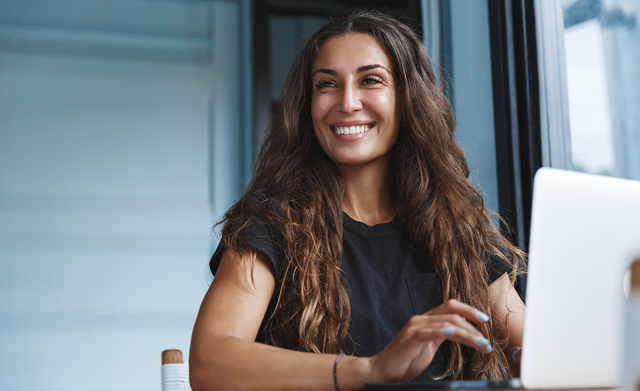 Happy female professional on laptop